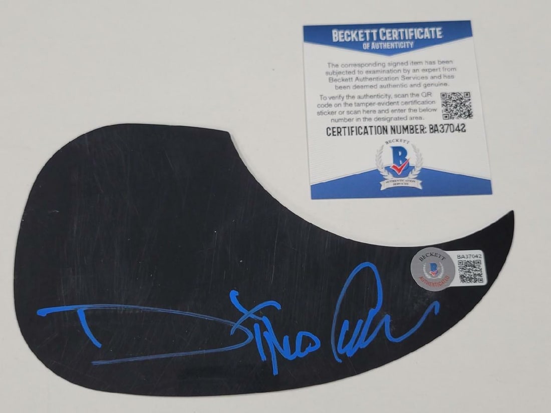 Fear Factory Black Pickguard Signed by Dino Cazares Beckett Authenticated: Fear Factory Black Pickguard Signed by Dino Cazares Beckett Authenticated This is an original black guitar pickguard signed by Dino Cazares of Fear Factory. The autograph is authenticated by Beckett a