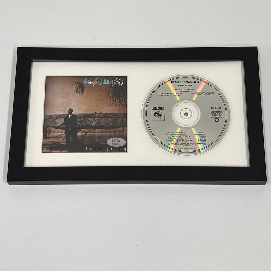 Branford Marsalis Signed Trio Jeepy CD Cover Framed PSA/DNA Authenticated: Branford Marsalis Signed Trio Jeepy CD Cover Framed PSA/DNA Authenticated This framed CD album cover features the signature of renowned saxophonist Branford Marsalis, authentically verified by PSA/DNA