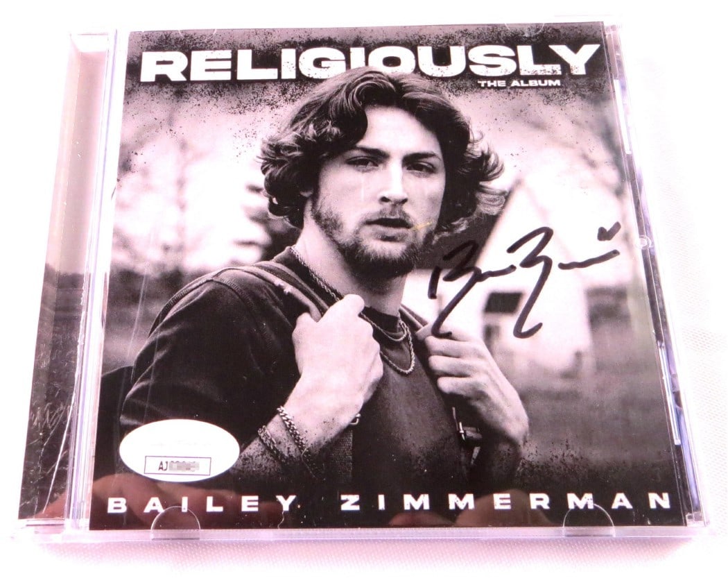 Bailey Zimmerman Signed Religiously Album CD Booklet With JSA Authentication: Bailey Zimmerman Signed Religiously Album CD Booklet With JSA Authentication This listing features a pre-owned Bailey Zimmerman autographed CD booklet for 'Religiously The Album.' The CD booklet comes