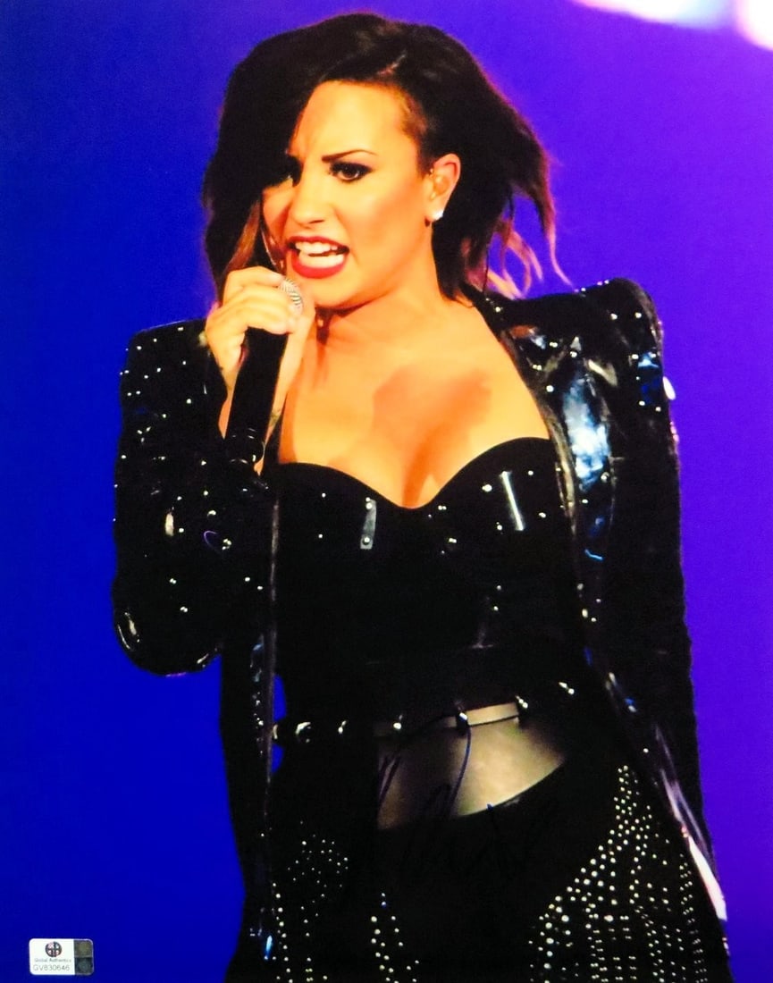 Demi Lovato 11X14 Signed Photo Certified by Global Authentics: Demi Lovato 11X14 Signed Photo Certified by Global Authentics This stunning 11X14 photograph features Demi Lovato in a captivating black outfit as she sings. The photo is autographed by Demi Lovato an
