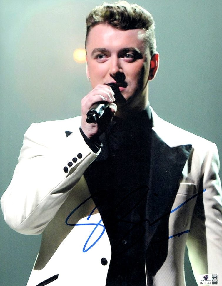Sam Smith Autographed 11x14 Photo Certified by Global Authentics: Sam Smith Autographed 11x14 Photo Certified by Global Authentics Capture a moment in music history with this stunning 11X14 photograph of Sam Smith, captured in a striking white jacket during a perfor