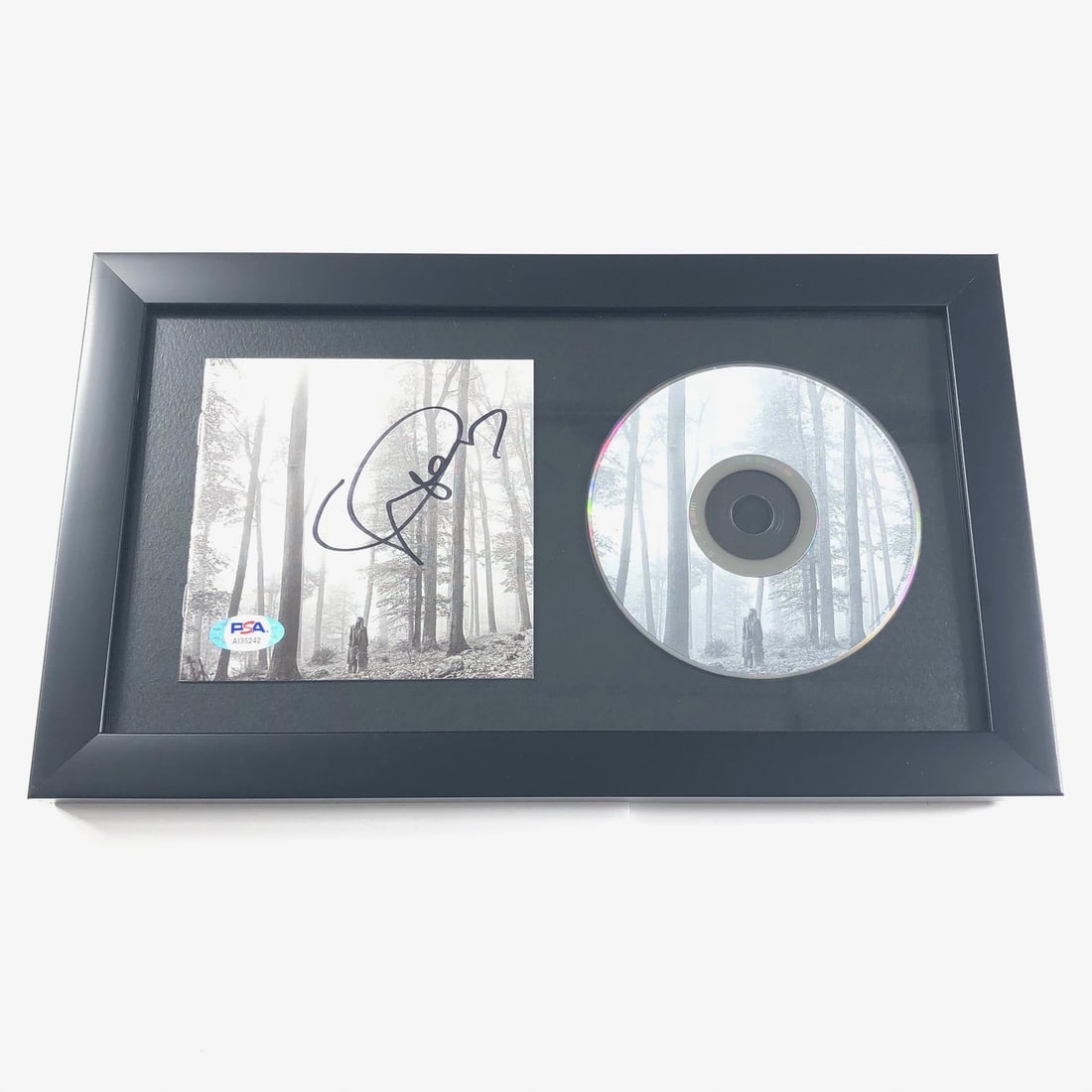 Framed Taylor Swift Signed Folklore CD Cover PSA/DNA Authenticated: Framed Taylor Swift Signed Folklore CD Cover PSA/DNA Authenticated This stunning framed CD album cover features the iconic signature of Taylor Swift, adorned on the artwork of her acclaimed album 'Fol