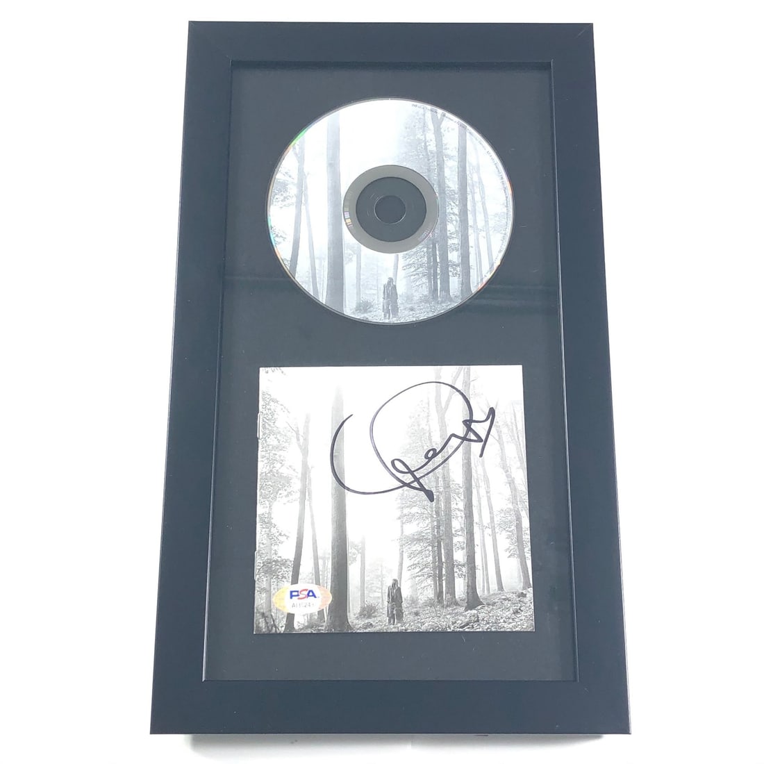 Taylor Swift Folklore Signed CD Cover Framed PSA/DNA Authentic: Taylor Swift Folklore Signed CD Cover Framed PSA/DNA Authentic This listing features a framed CD album cover of Taylor Swift's 'Folklore,' elegantly showcasing her authentic signature. The autograph h