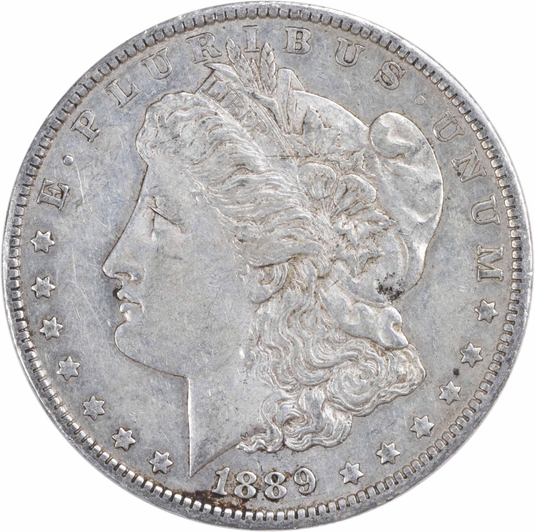 1889-O Morgan Silver Dollar AU Uncertified 90% Silver New Orleans: 1889-O Morgan Silver Dollar AU Uncertified 90% Silver New Orleans This 1889-O Morgan Silver Dollar is a remarkable piece of American numismatics, featuring a well-preserved AU (About Uncirculated) gra