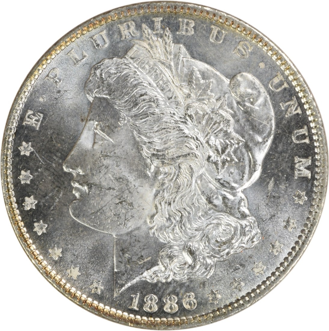 Choice BU 1886 Silver Morgan Dollar Uncirculated Uncertified: Choice BU 1886 Silver Morgan Dollar Uncirculated Uncertified This 1886 Morgan Silver Dollar is a choice brilliant uncirculated coin, featuring no mint mark and composed of silver. It remains uncertifi