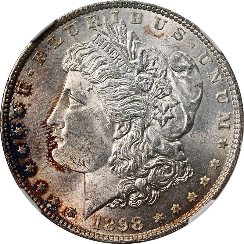NGC MS63 1898-P Morgan Silver Dollar with Toned Appearance: NGC MS63 1898-P Morgan Silver Dollar with Toned Appearance This 1898-P Morgan Silver Dollar is certified by NGC with a grade of MS63. It features notable toning and a bright white reverse. The coin is