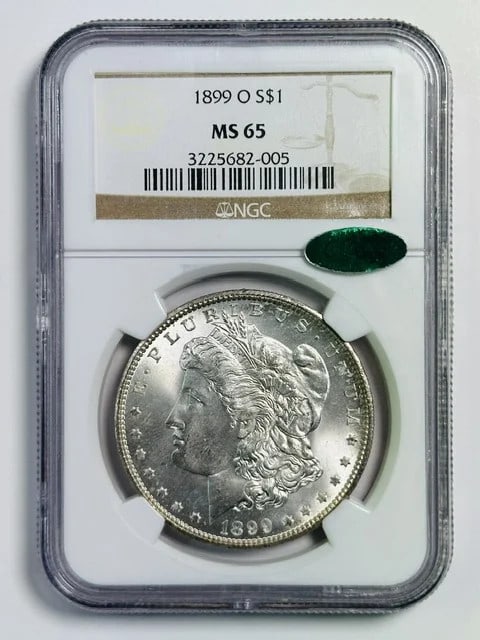 1899 New Orleans Morgan Dollar NGC MS65 CAC: 1899 New Orleans Morgan Dollar NGC MS65 CAC This 1899 Morgan Silver Dollar was minted in New Orleans and is graded MS 65 by NGC, with an additional CAC designation for premium quality. Composed of sil