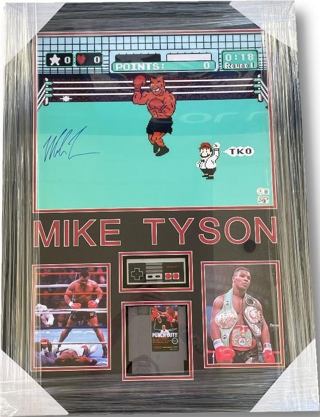 Mike Tyson Signed Framed 16x20 Photo with Punch Out Game Beckett Authenticated: Mike Tyson Signed Framed 16x20 Photo with Punch Out Game Beckett Authenticated This striking custom framed piece features a hand-signed boxing glove by the legendary Mike Tyson, authenticated by Becke