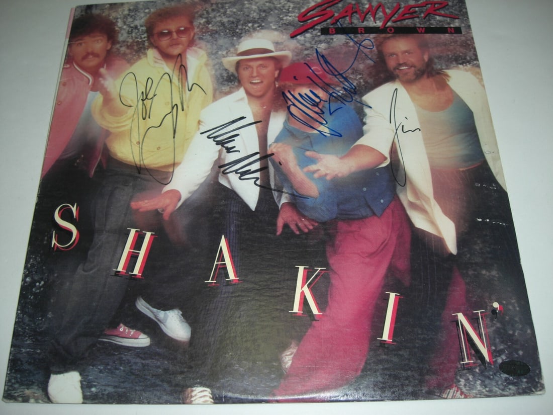 Signed Shakin LP Album by Sawyer Brown with Hologram Authentication: Signed Shakin LP Album by Sawyer Brown with Hologram Authentication This is a pre-owned original LP record album by country music stars Sawyer Brown, titled 'Shakin'.' The album features hologram sign