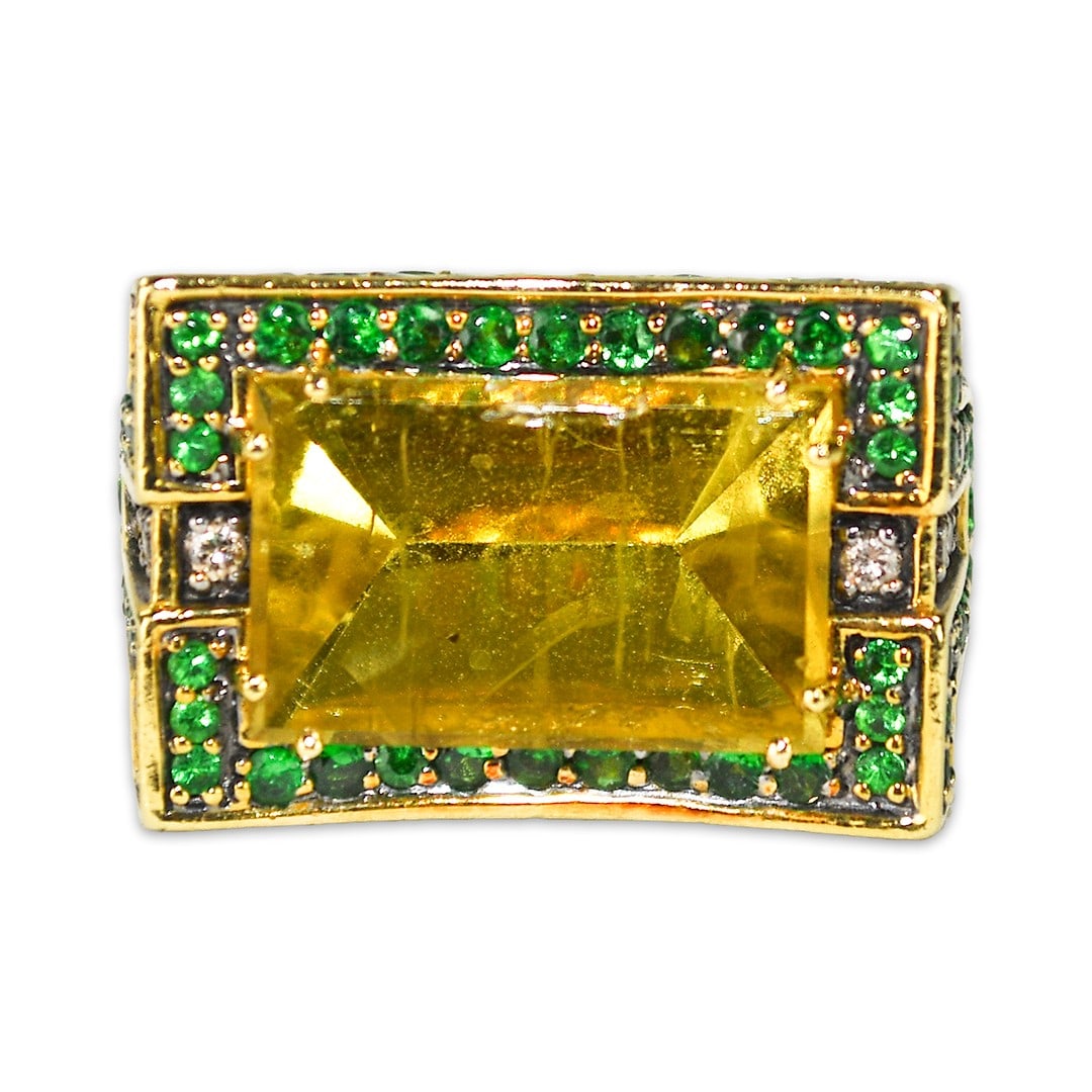 18k Yellow Gold Cocktail Ring with Yellow Quartz and Tsavorite Garnet: 18k Yellow Gold Cocktail Ring with Yellow Quartz and Tsavorite Garnet This custom-made ladies' cocktail ring features a striking rectangle yellow quartz as the centerpiece, set in 18k yellow gold. The