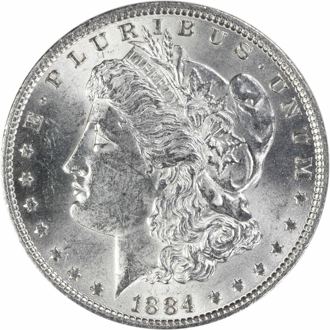 1884 Philadelphia Morgan Dollar AU Uncertified Silver Coin: 1884 Philadelphia Morgan Dollar AU Uncertified Silver Coin This 1884 Morgan Silver Dollar is an attractive example of the classic U.S. coin, featuring a composition of 90% silver and 10% copper. Desig