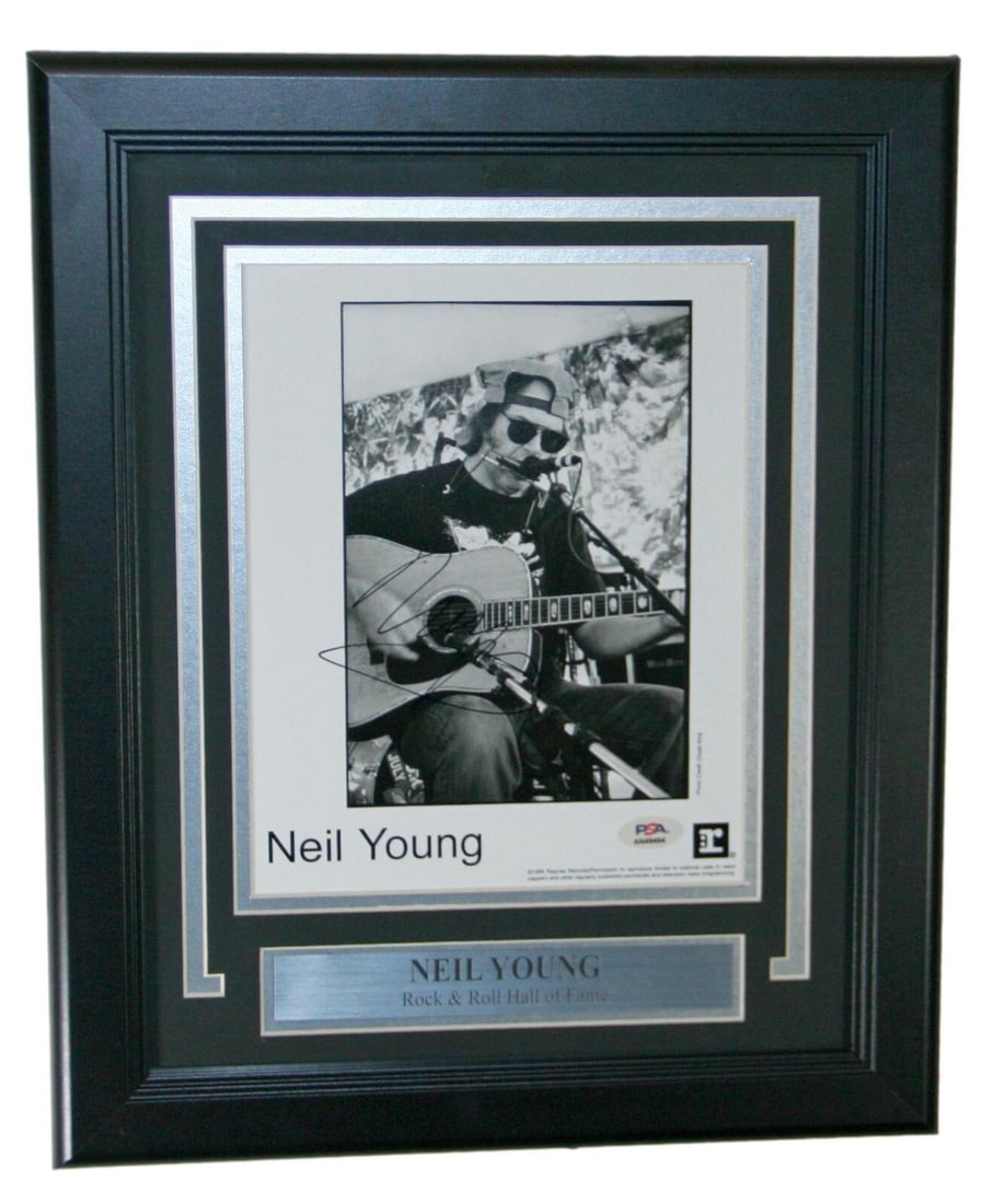 Neil Young Signed Framed 8x10 Photo PSA/DNA Authentic: Neil Young Signed Framed 8x10 Photo PSA/DNA Authentic This authentic Neil Young autographed 8x10 framed photograph captures the essence of the legendary rock artist. Featuring a clear signature authen