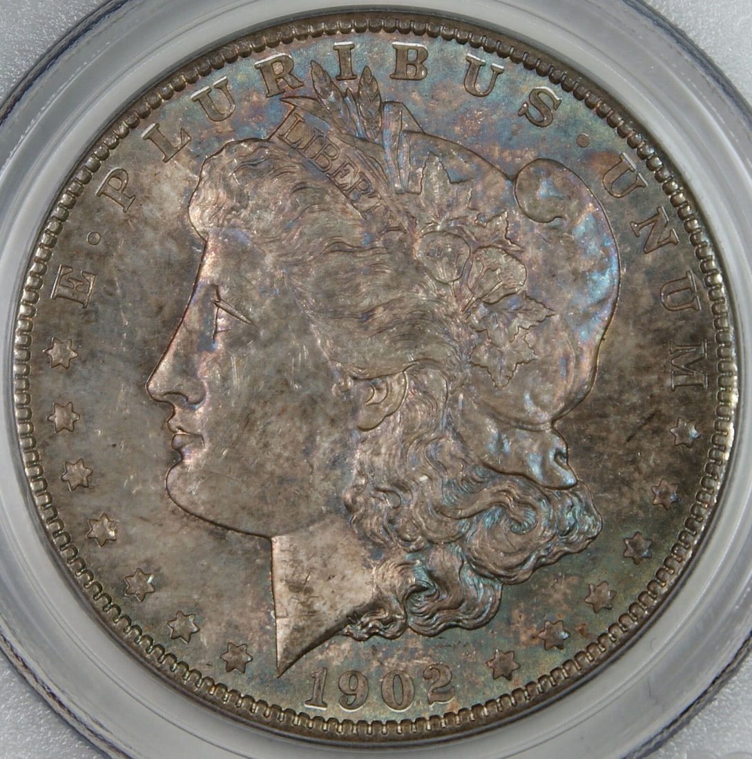 PCGS MS-63 1902-O Morgan Dollar Toned Silver Coin: PCGS MS-63 1902-O Morgan Dollar Toned Silver Coin This 1902-O Morgan Silver Dollar is graded MS-63 by PCGS and features vivid toning with attractive, colorful highlights. Struck in New Orleans, this u