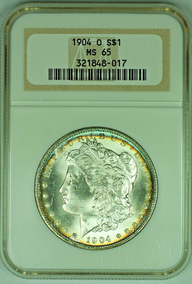 Toned 1904-O Morgan Dollar Silver $1 NGC MS 65 Certified Coin: Toned 1904-O Morgan Dollar Silver $1 NGC MS 65 Certified Coin This 1904-O Morgan Silver Dollar is a $1 coin from the United States, featuring a natural toned appearance. It is an uncirculated coin, gr