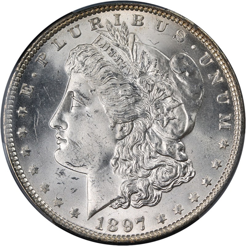 PCGS MS63 1897 Morgan Dollar Philadelphia Mint Silver Coin Blast White: PCGS MS63 1897 Morgan Dollar Philadelphia Mint Silver Coin Blast White This original 1897-P Morgan Silver Dollar is graded PCGS MS63, showcasing superb eye appeal with exceptional luster and a strong 