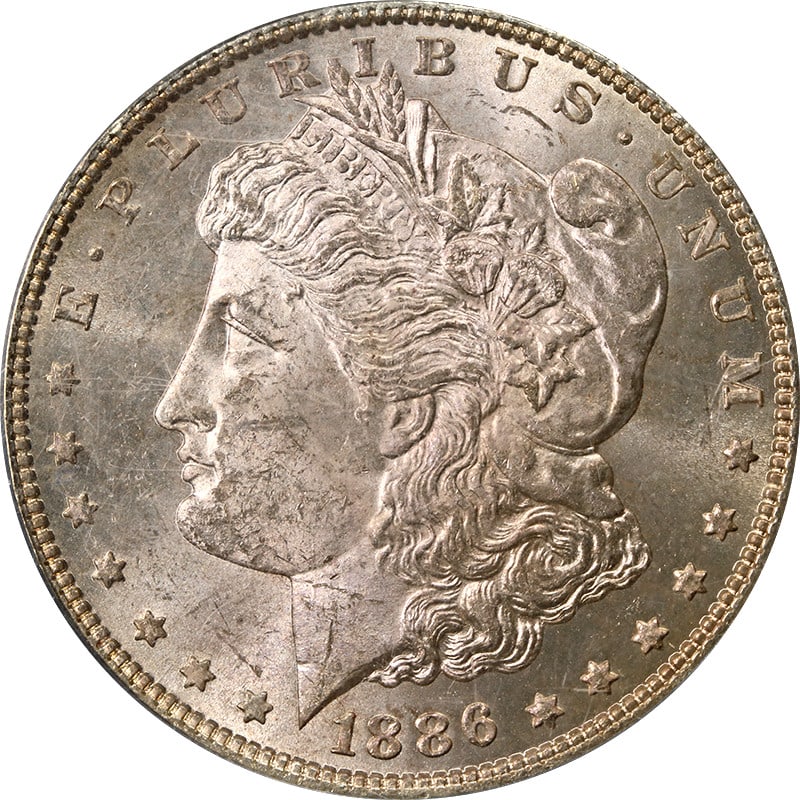 1886 P Morgan Silver Dollar PCGS MS63 OGH Toning: 1886 P Morgan Silver Dollar PCGS MS63 OGH Toning This is an 1886-P Morgan Silver Dollar graded MS63 by PCGS and housed in an Old Green Holder (OGH). The coin is uncirculated and features attractive to