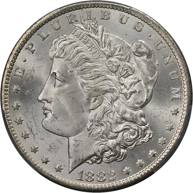 PCGS MS64 1882 CC Morgan Silver Dollar Blast White: PCGS MS64 1882 CC Morgan Silver Dollar Blast White This is an 1882-CC Morgan Silver Dollar graded MS64 by PCGS. The coin is uncirculated and features a brilliant blast white appearance with strong lus