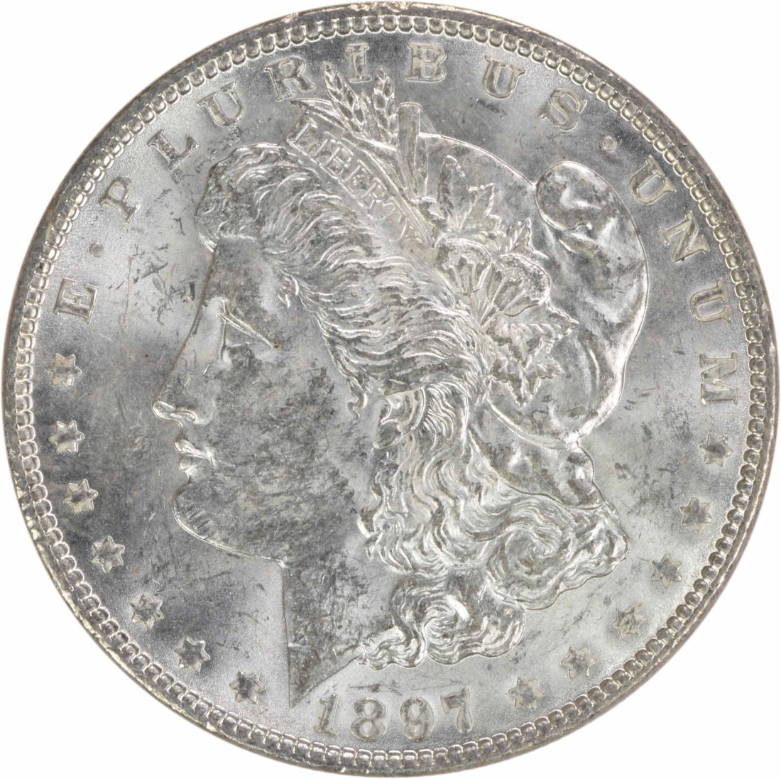 1897 Silver Morgan Dollar Brilliant Uncirculated Uncertified US Coin: 1897 Silver Morgan Dollar Brilliant Uncirculated Uncertified US Coin This is an 1897 Morgan Silver Dollar from the United States, featuring a brilliant uncirculated (BU) condition. The coin is compose