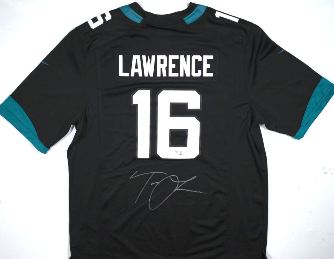 Fanatics Authenticated Signed Black Jaguars Game Jersey by Trevor Lawrence: Fanatics Authenticated Signed Black Jaguars Game Jersey by Trevor Lawrence This is a pre-owned Jacksonville Jaguars black game jersey autographed by Trevor Lawrence. The autograph has been authenticat