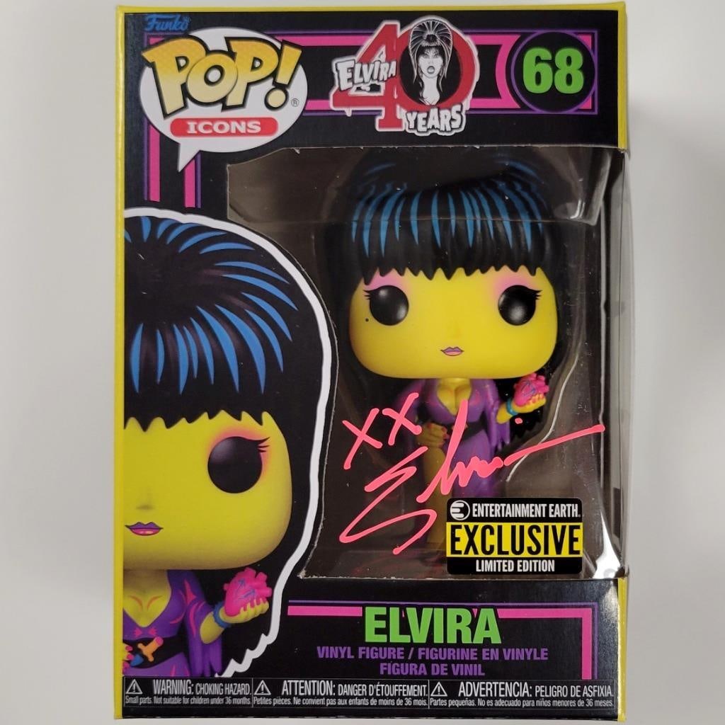 Autographed Elvira Pink Black Light Funko Pop Beckett Authenticated: Autographed Elvira Pink Black Light Funko Pop Beckett Authenticated This is an original Black Light edition Funko Pop figure from the movie Mistress of the Dark, signed by Elvira. The autograph is aut