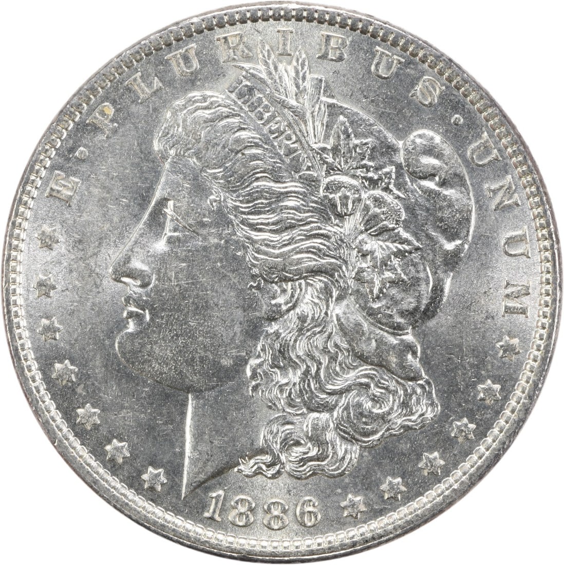 1886 BU Morgan Dollar Silver Coin Uncertified No Mint Mark: 1886 BU Morgan Dollar Silver Coin Uncertified No Mint Mark This 1886 Morgan Silver Dollar is an uncirculated coin with a bright uncirculated (BU) grade. Struck in silver, it features no mint mark and 