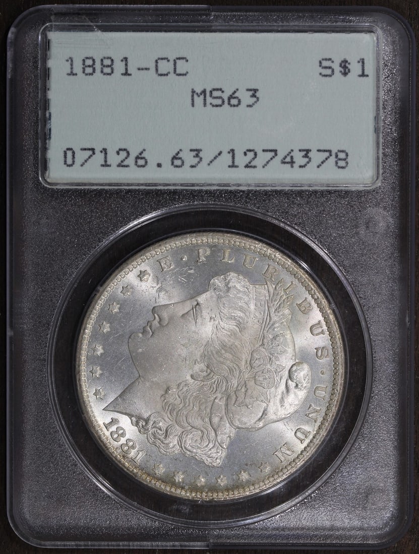 Morgan Dollar 1881 Carson City MS63 Silver PCGS Rattler Holder: Morgan Dollar 1881 Carson City MS63 Silver PCGS Rattler Holder This is an un-used 1881-CC Morgan Silver Dollar graded MS63 by PCGS and housed in a rattler holder. Minted in Carson City, this coin feat