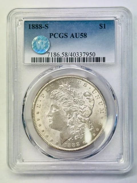1888-S Morgan Silver Dollar PCGS AU58: 1888-S Morgan Silver Dollar PCGS AU58 This 1888 Morgan Silver Dollar was minted in San Francisco and has been graded AU-58 by PCGS. Composed of silver, this pre-owned coin offers a high level of detai