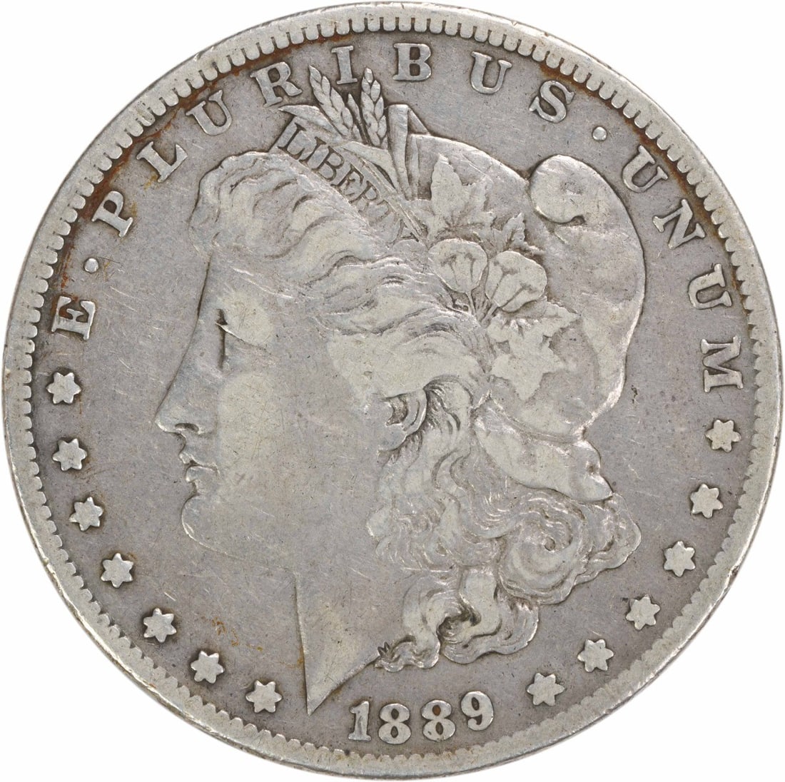 1889 CC Morgan Silver Dollar VF Uncertified 90% Silver Coin: 1889 CC Morgan Silver Dollar VF Uncertified 90% Silver Coin This 1889-CC Morgan Silver Dollar is a captivating piece of numismatic history. Featuring a design by George T. Morgan, this coin showcases 