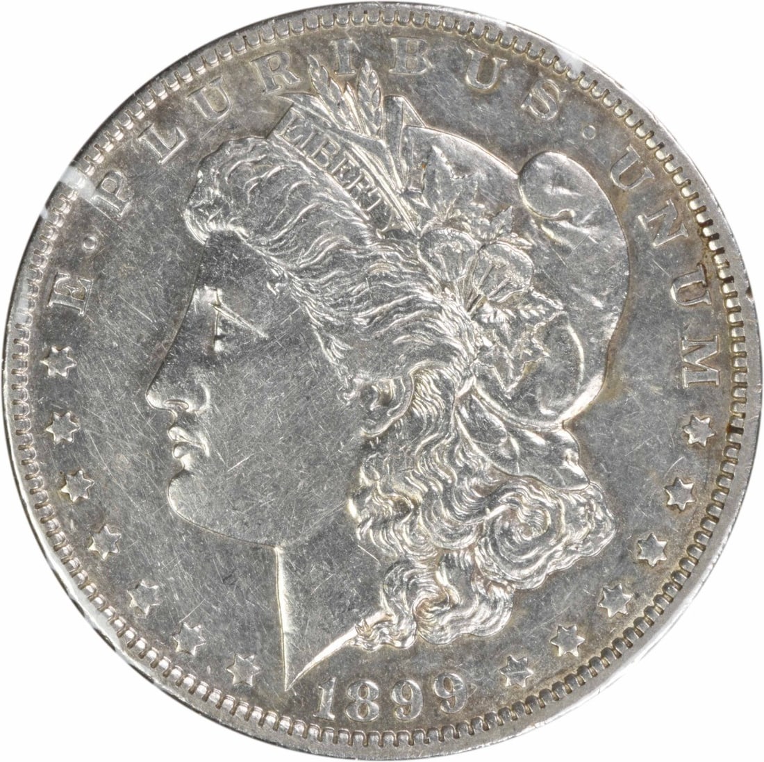 1899 Morgan Dollar VAM 5 Micro O Variety AU Uncertified US Coin: 1899 Morgan Dollar VAM 5 Micro O Variety AU Uncertified US Coin This is an 1899 Morgan Silver Dollar featuring the VAM 5 Micro O Wing Lines variety. Minted in New Orleans, this circulated coin is comp
