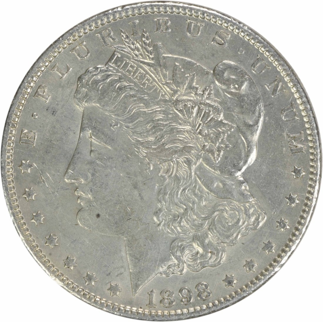 1898 Morgan Silver Dollar AU Uncertified 90% Silver Philadelphia Mint: 1898 Morgan Silver Dollar AU Uncertified 90% Silver Philadelphia Mint This 1898 Morgan Silver Dollar showcases a stunning design by George T. Morgan, a hallmark of American numismatics. The coin featu