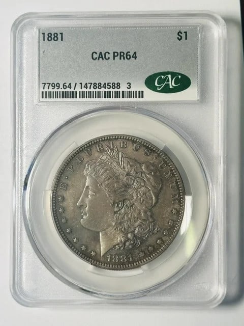 1881 Morgan Silver Dollar Proof 64 CAC Certified: 1881 Morgan Silver Dollar Proof 64 CAC Certified This 1881 Morgan Silver Dollar is a proof strike graded PR 64 and certified by CAC. It is composed of silver and originates from the United States. The