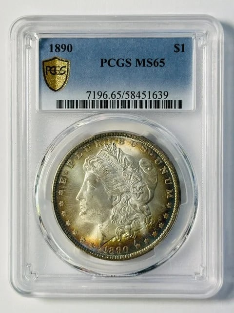 PCGS MS-65 1890 Morgan Silver Dollar Pretty Toning: PCGS MS-65 1890 Morgan Silver Dollar Pretty Toning This 1890 Morgan Silver Dollar is graded MS-65 by PCGS and features attractive toning. Struck at the Philadelphia Mint, it is composed of silver and 