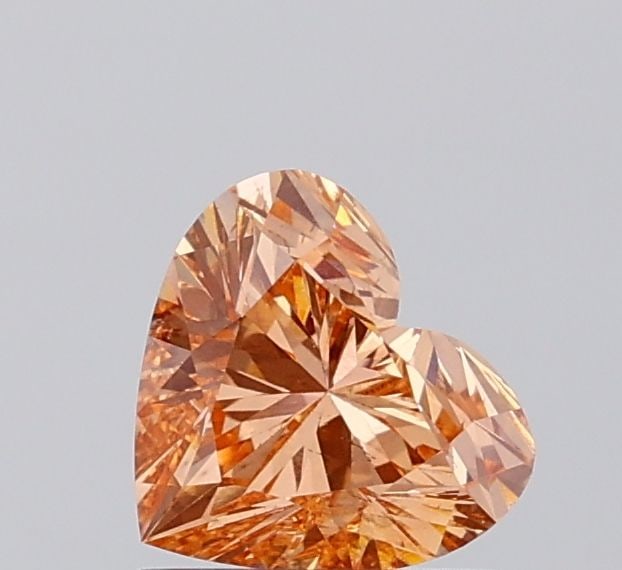 Loose Diamond - HEART 1.02ct Fancy Vivid Pinkish Orange SI1: Loose Diamond - HEART 1.02ct Fancy Vivid Pinkish Orange SI1 Source: This is a real non-mined Diamond that has been grown in a lab Shape: HEART Carats: 1.02 Color: Fancy Vivid Pinkish Orange Certificat
