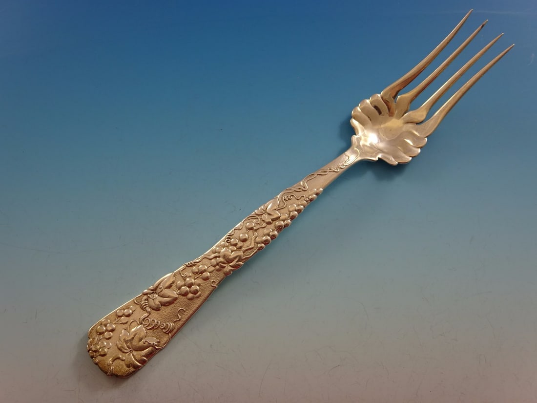 Tiffany & Co Vine Sterling Silver Cold Meat Fork 8 3/4": Tiffany & Co Vine Sterling Silver Cold Meat Fork 8 3/4" This exquisite serving fork from the renowned Vine pattern by Tiffany & Co. showcases a stunning design featuring grapes and grapevines. Crafted