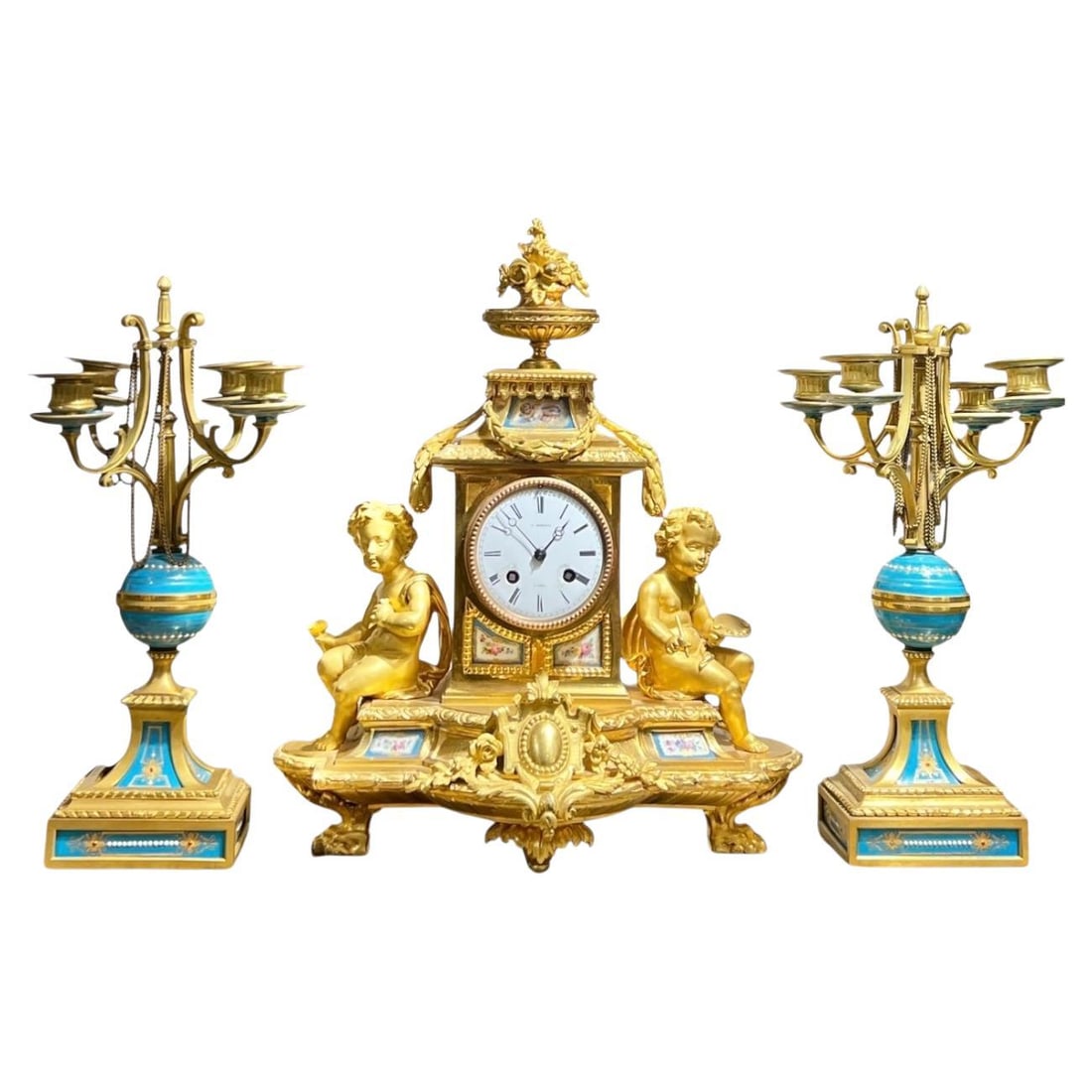 Set of 3 French Ormolu Bronze Louis XVI Mantel Clock with Sevres Style Candelabra: Set of 3 French Ormolu Bronze Louis XVI Mantel Clock with Sevres Style Candelabra This late 19th century French Louis XVI style garniture set features a mantel clock and a matching pair of four-light 