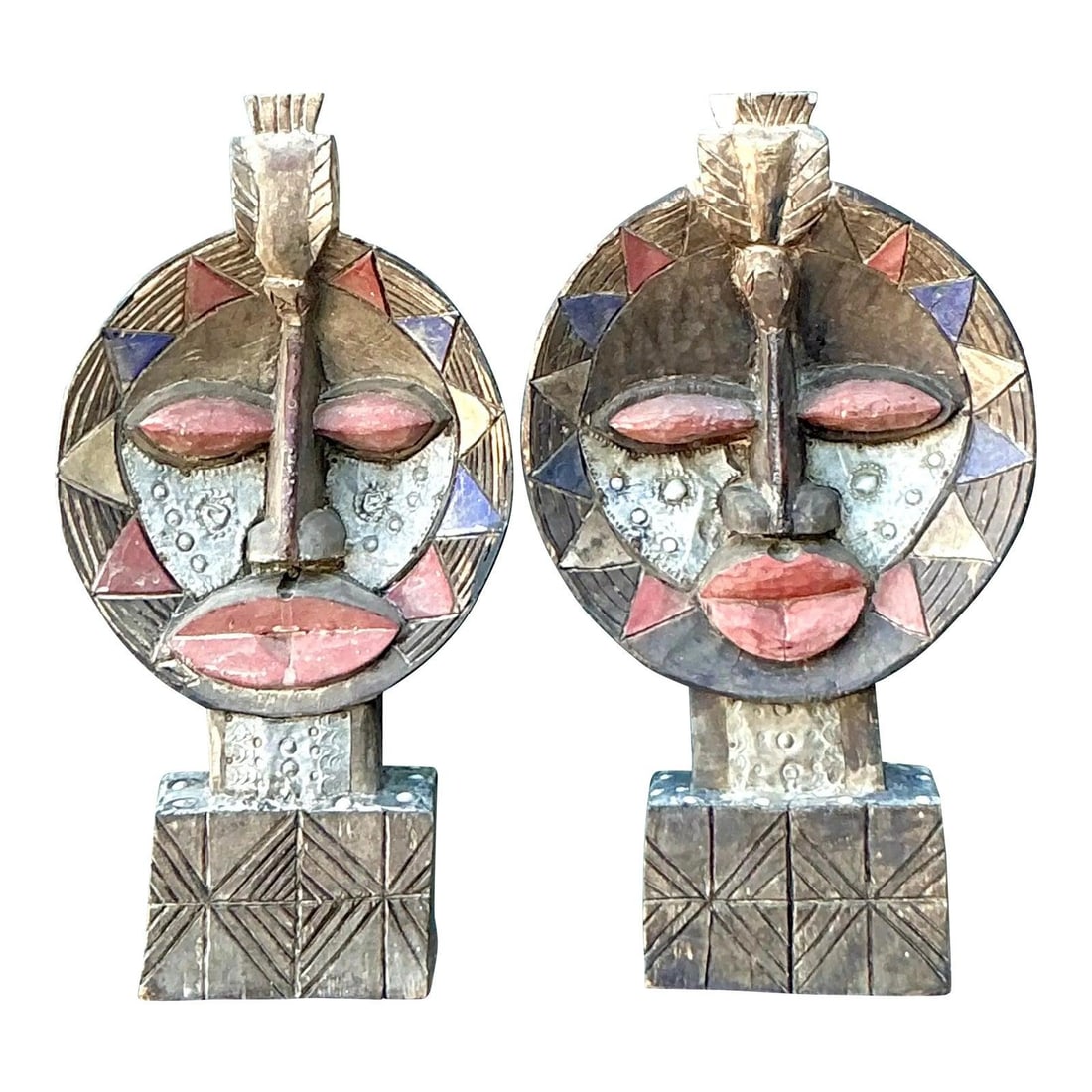 Pair of Hand Carved Wood Bohemian Tribal Style Masks with Metal Overlay Set of 2: Pair of Hand Carved Wood Bohemian Tribal Style Masks with Metal Overlay Set of 2 This pair of vintage hand-carved wooden tribal masks features circular forms adorned with intricate metal repousse over