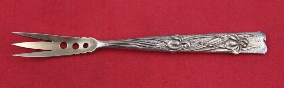 Tiffany & Co. Vine Sterling Silver Olive Fork Iris Motif 4 5/8": Tiffany & Co. Vine Sterling Silver Olive Fork Iris Motif 4 5/8" This exquisite olive fork is part of the Vine pattern by Tiffany & Co., crafted from high-quality sterling silver. The fork features a b