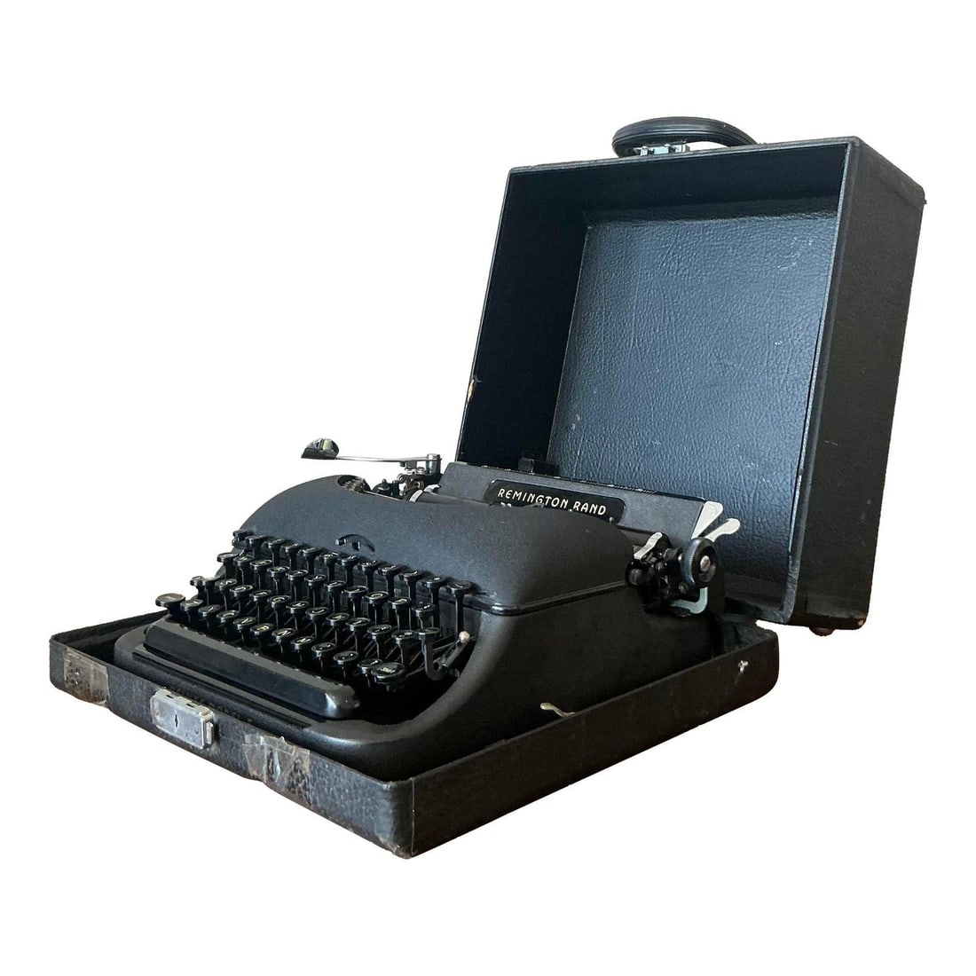 Midcentury Remington Rand Manual Typewriter with Original Carrying Case: Midcentury Remington Rand Manual Typewriter with Original Carrying Case This vintage Remington Rand typewriter showcases mid-20th-century craftsmanship and design, featuring a sleek black finish and d