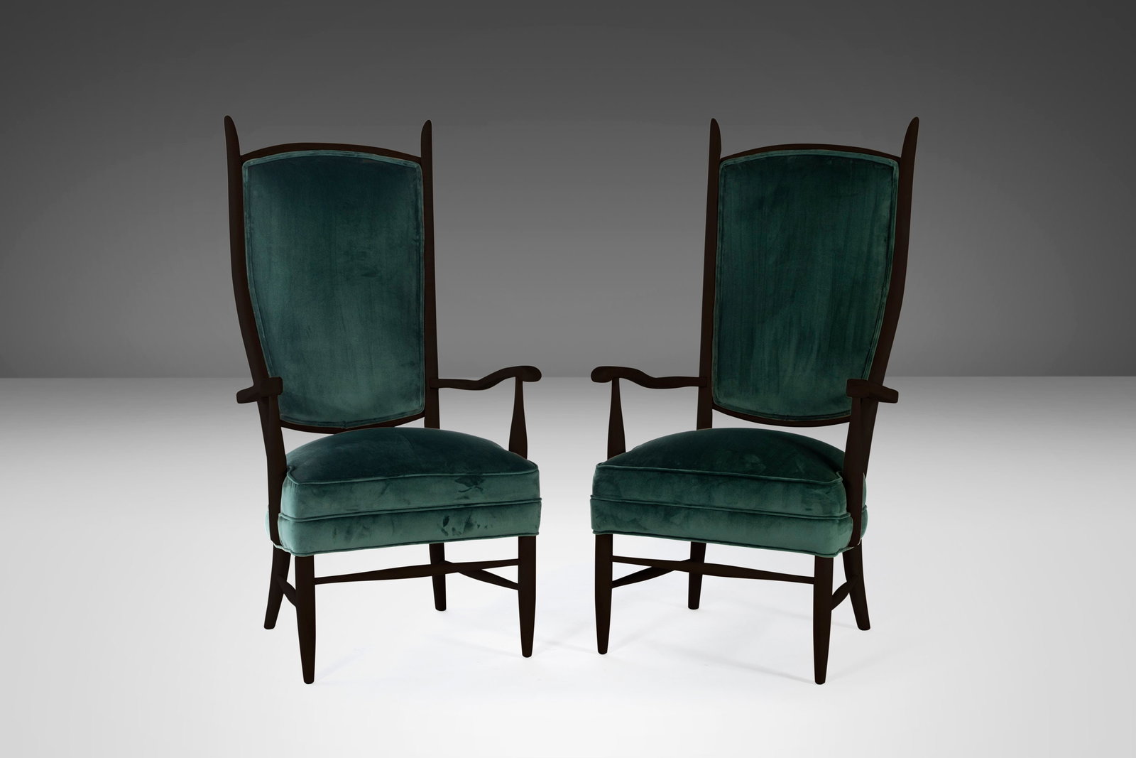 Pair of 1950s Maxwell Royal High Back Upholstered Chairs in Forest Green Velvet: Pair of 1950s Maxwell Royal High Back Upholstered Chairs in Forest Green Velvet This exquisite set of two high back upholstered chairs showcases a striking ebonized wood finish with tapered