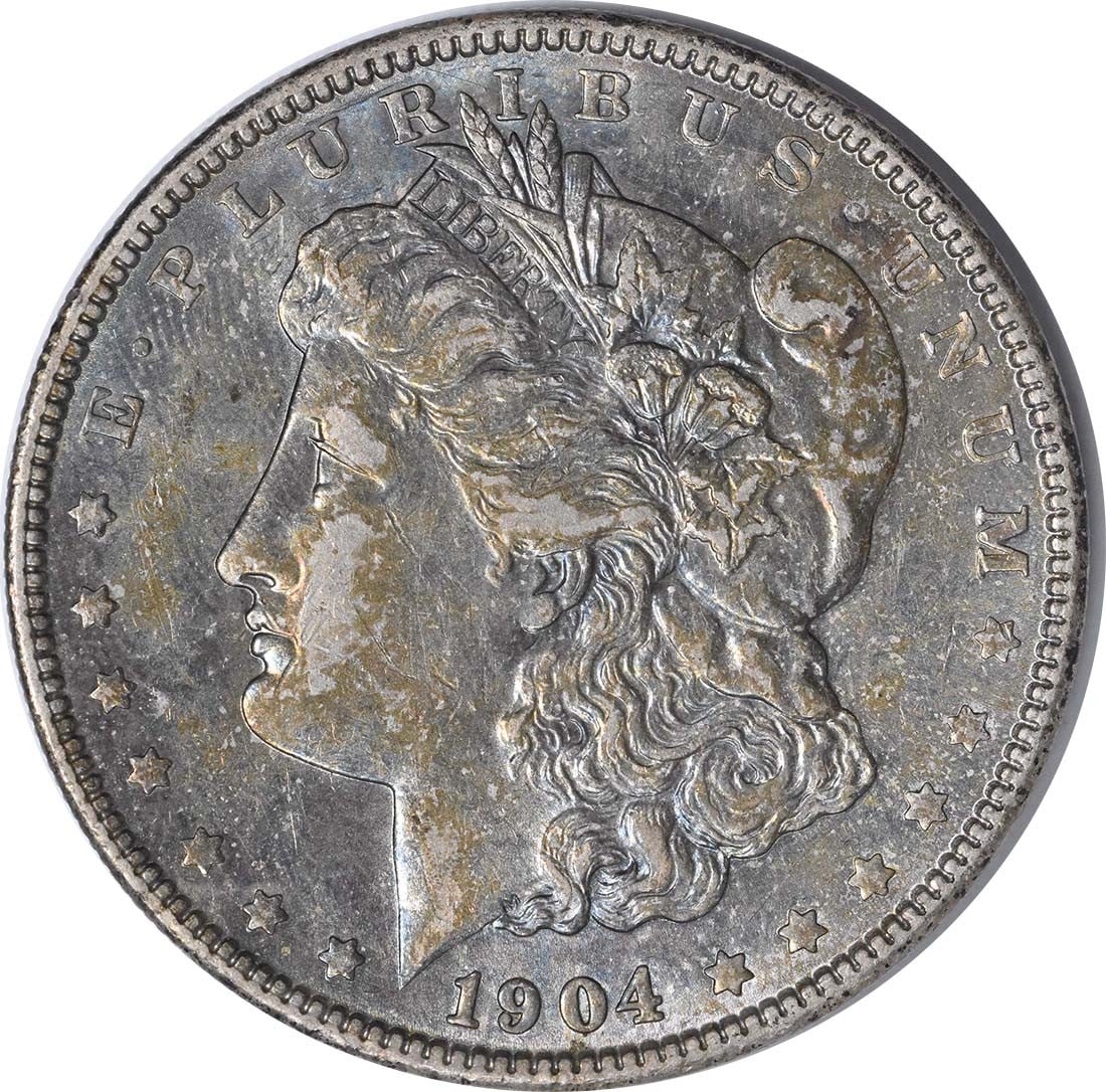 1904 Morgan Silver Dollar AU Uncertified 90% Silver Coin: 1904 Morgan Silver Dollar AU Uncertified 90% Silver Coin This 1904 Morgan Silver Dollar, graded AU, showcases the classic design by George T. Morgan. Struck in Philadelphia, this coin consists of 90% 