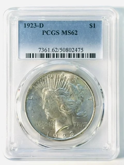 1923 Denver Peace Dollar PCGS MS62 Silver: 1923 Denver Peace Dollar PCGS MS62 Silver This 1923 D Peace Dollar is graded MS-62 by PCGS and features great luster. Struck in silver at the Denver Mint, this pre-owned coin is a valuable addition fo