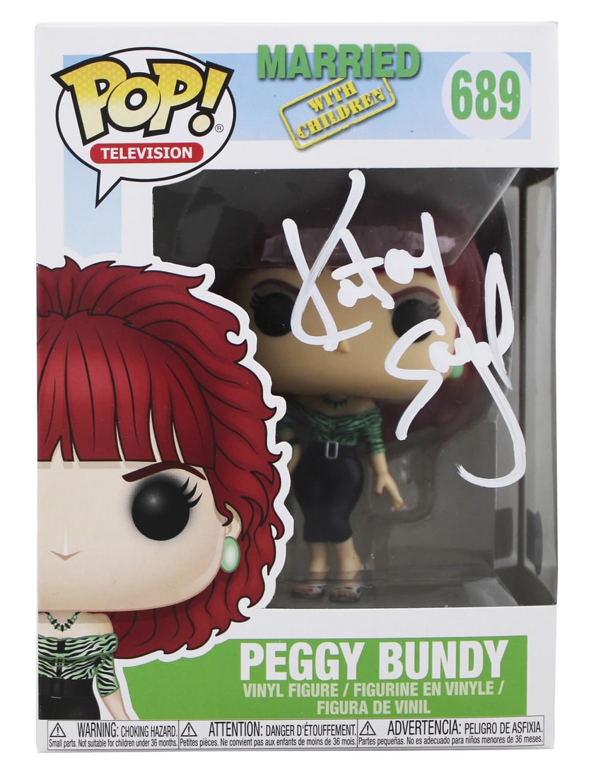 Peggy Bundy Funko Pop Signed by Katey Sagal Beckett Authenticated: Peggy Bundy Funko Pop Signed by Katey Sagal Beckett Authenticated This is a pre-owned Funko Pop Vinyl Figure of Peggy Bundy (#689) from "Married... with Children," personally signed by Katey Sagal. Th