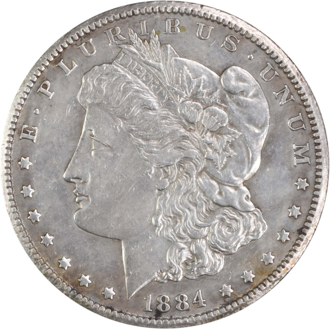 1884 Carson City Morgan Silver Dollar AU Uncertified Coin: 1884 Carson City Morgan Silver Dollar AU Uncertified Coin This 1884-CC Morgan Silver Dollar is a remarkable piece of numismatic history. Struck in 1884 at the Carson City Mint, this coin showcases the