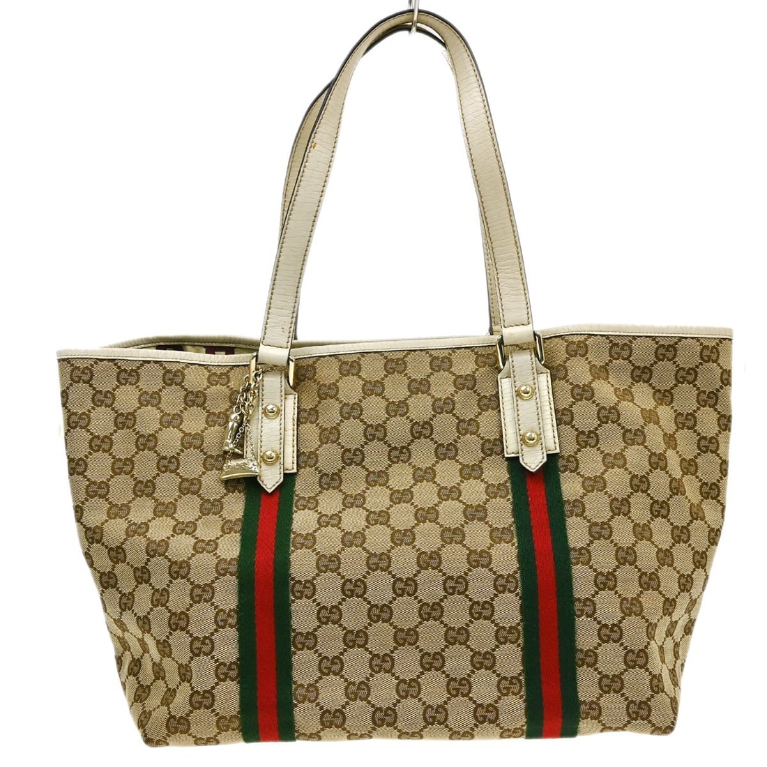 Gucci Shelly Medium GG Canvas Leather Tote in Beige: Gucci Shelly Medium GG Canvas Leather Tote in Beige Vintage Gucci Shelly GG tote bag in beige canvas and leather with brown lining. This medium tote features the Gucci GG pattern and signature red and