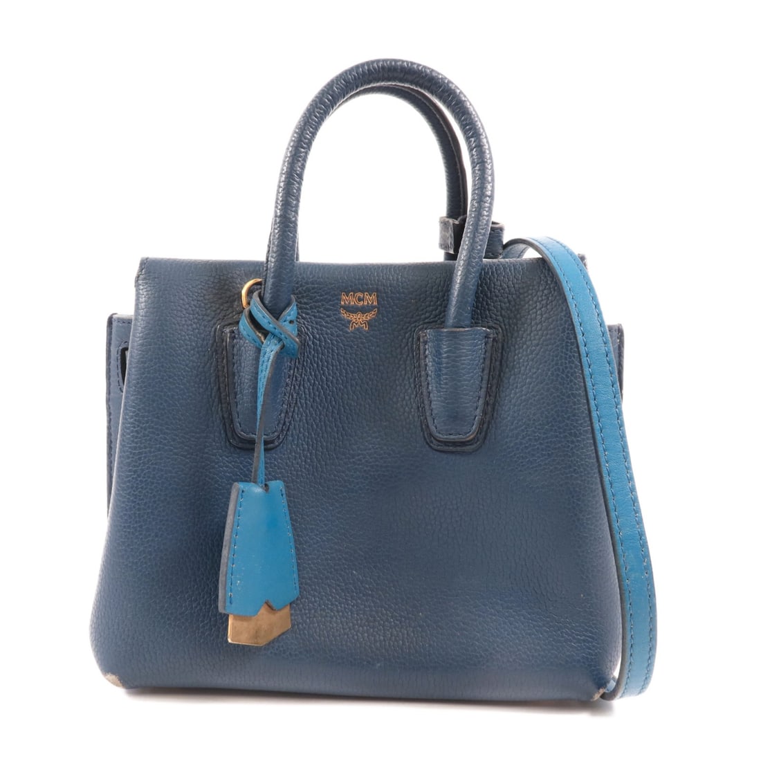 MCM Blue Calfskin 2 Way Shoulder Bag Handbag: MCM Blue Calfskin 2 Way Shoulder Bag Handbag This MCM 2-way shoulder bag is crafted from blue calfskin leather and features gold-tone hardware. Designed for versatility, it can be carried as a handbag