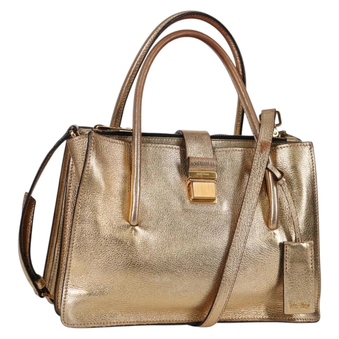 Gold Leather Miu Miu Madras Tote with Convertible Compartments: Gold Leather Miu Miu Madras Tote with Convertible Compartments This Miu Miu Madras Convertible Compartment Tote is crafted from gold leather and designed for women. The pre-owned handbag features a co