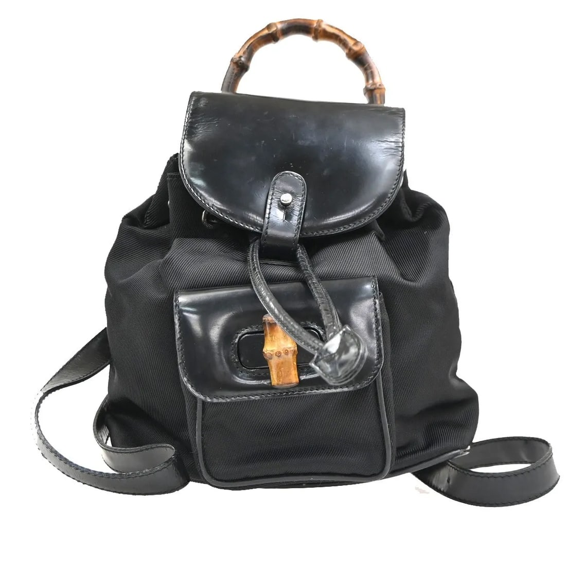 Gucci Vintage Bamboo Backpack Black Nylon and Patent Leather: Gucci Vintage Bamboo Backpack Black Nylon and Patent Leather This Gucci Vintage Bamboo Backpack is crafted from black nylon with patent leather accents. Designed for women, it features the iconic bamb