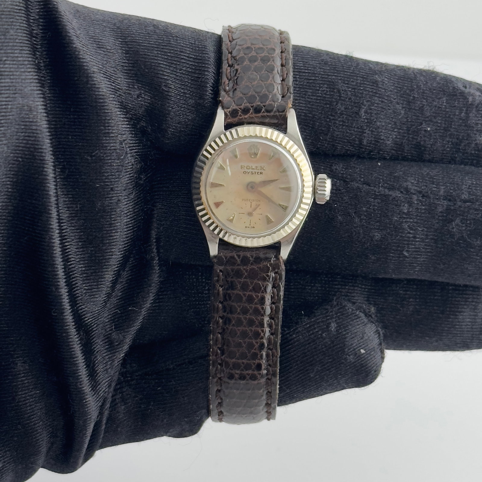 Rolex Ladies Oyster Precision 6527 Silver Dial Watch with Aftermarket Leather Band: Rolex Ladies Oyster Precision 6527 Silver Dial Watch with Aftermarket Leather Band This ladies Rolex Oyster Precision watch features a silver dial, a fluted white gold bezel, and a brown leather brace