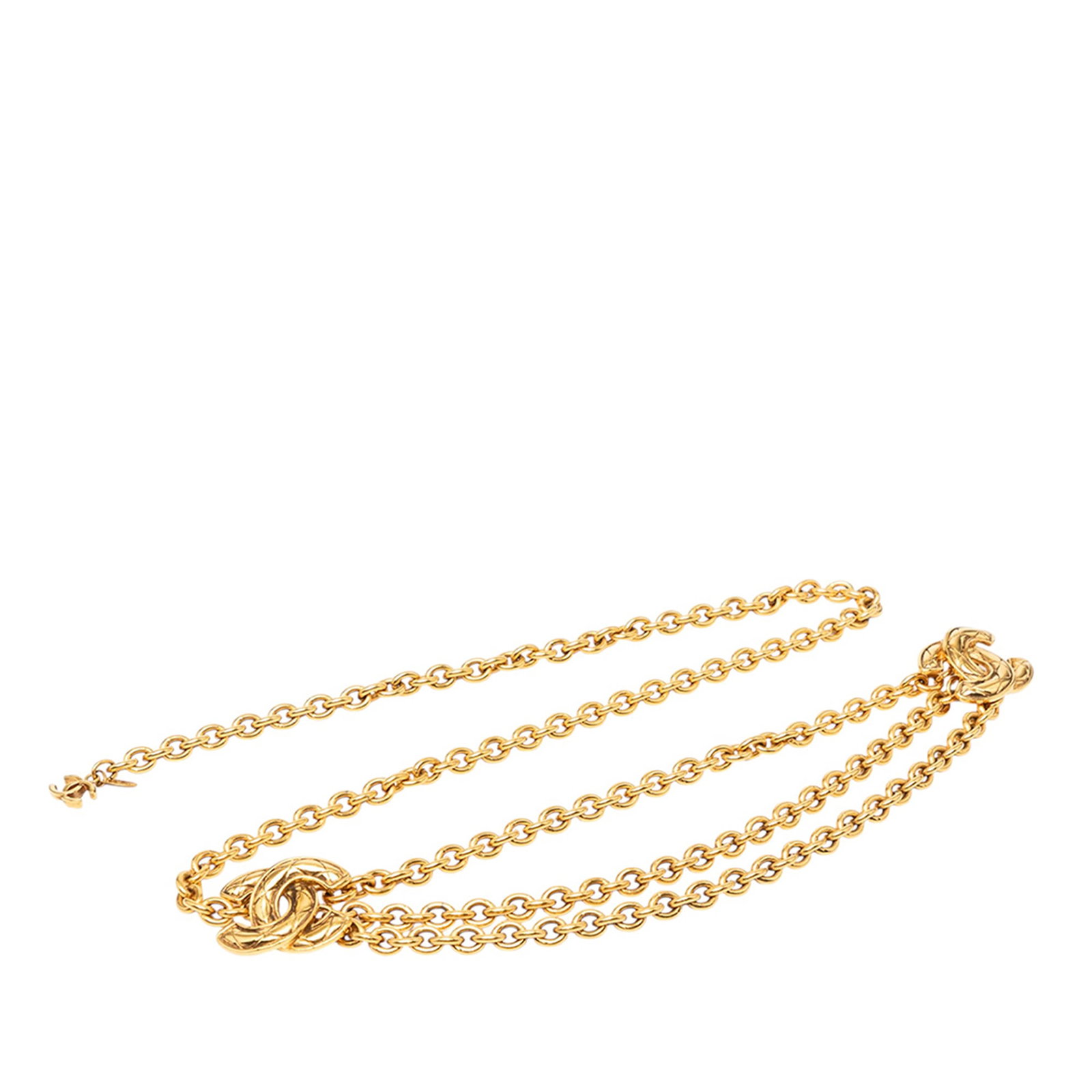 Chanel Quilted CC Triple Chain Gold Tone Belt: Chanel Quilted CC Triple Chain Gold Tone Belt Chanel gold-tone triple chain belt with a quilted CC motif and hook closure. Made in France. Condition is B+ with visible discoloration, scratches, and ru
