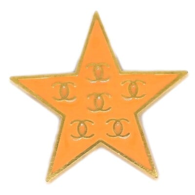 CHANEL 01P Orange Star Brooch Gold Plated Pin: CHANEL 01P Orange Star Brooch Gold Plated Pin Chanel star brooch pin in gold plated metal with orange detailing. Marked 01P and made in France. Condition is very good overall, with visible scratches a